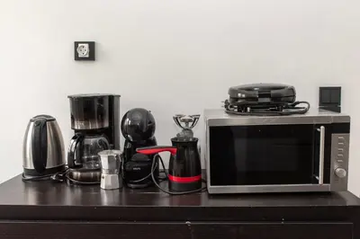 a microwave sitting on top of a kitchen counter at Esperidon Luxury Apartment Glyfada in Athens