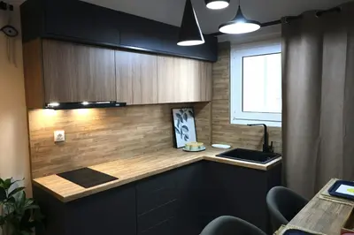 a kitchen with black cabinets and a sink and a window at Marina Zeas Seaside Studio-MarinaQ in Piraeus