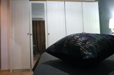 a black pillow sitting on top of a bed at Marina Zeas Seaside Studio-MarinaQ in Piraeus