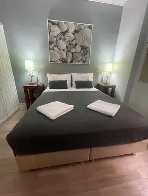 a bedroom with a large bed with two towels on it at Marina Zeas Seaside Studio-MarinaQ in Piraeus
