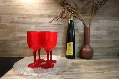 two red glasses sitting next to a bottle of wine at Marina Zeas Seaside Studio-MarinaQ in Piraeus
