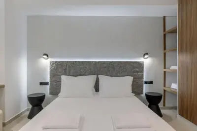 a bedroom with a large white bed with white pillows at Loom Suite Downtown Athens in Athens