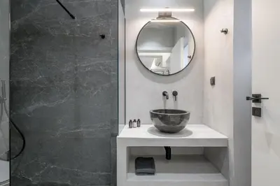 a bathroom with a bowl sink and a shower at Loom Suite Downtown Athens in Athens