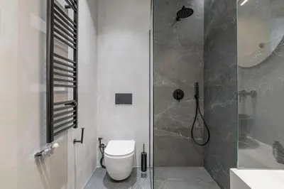 a bathroom with a shower and a toilet and a sink at Loom Suite Downtown Athens in Athens