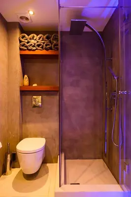 a bathroom with a shower with a toilet and a glass shower door at Athens riviera beach villa in Anavissos