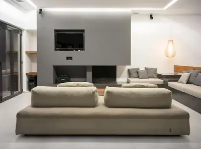 a living room with two ottomans in a living room at Athens riviera beach villa in Anavissos