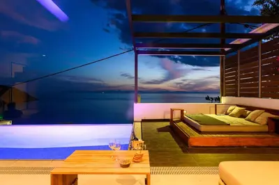 a room with a bed and a view of the ocean at Athens riviera beach villa in Anavissos