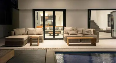 a living room with couches and a pool at Athens riviera beach villa in Anavissos
