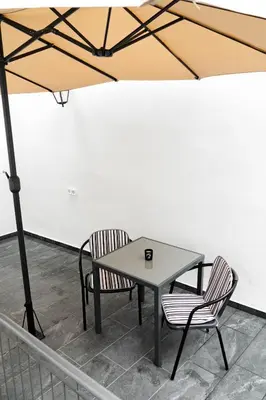 a table and two chairs under a tent at Larissa Railway &Metro station apartment in Athens