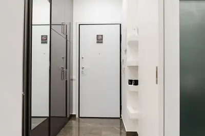 a row of glass doors in a room with shelves at Larissa Railway &Metro station apartment in Athens