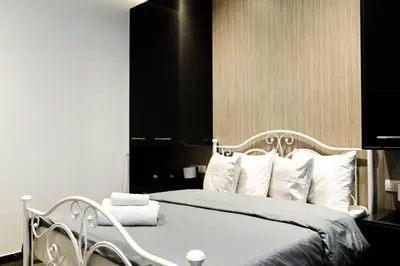 a bedroom with a white bed with white pillows at Larissa Railway &Metro station apartment in Athens