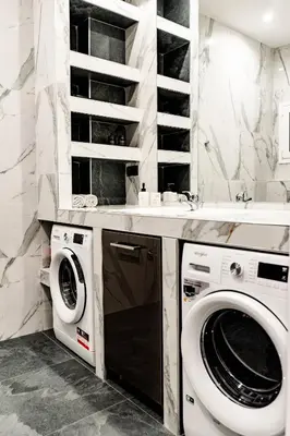 a white laundry room with a washer and dryer at Larissa Railway &Metro station apartment in Athens