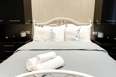 a hotel room with a bed with towels on it at Larissa Railway &Metro station apartment in Athens