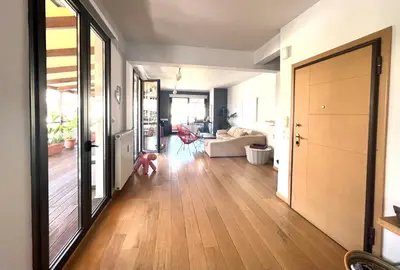 a living room with a hard wood floor and a hallway at Herodion Residence in Athens