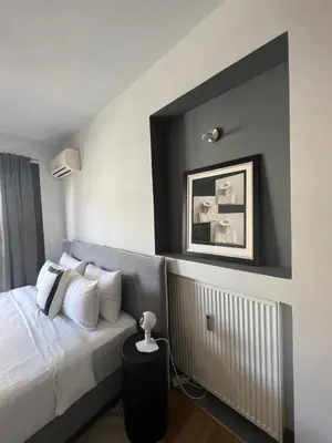 a bedroom with a bed and a picture on the wall at Herodion Residence in Athens