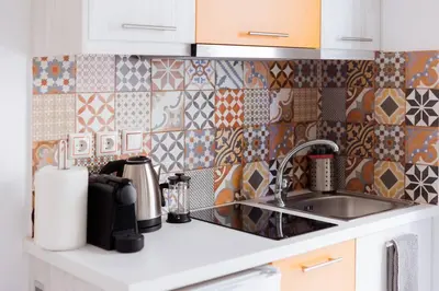 a kitchen counter with a sink and tiles on the wall at Cosy studio in the Petralona neighbourhood in Athens