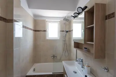 a bathroom with a tub and a sink and a shower at Athens Acropolis View Penthouse-Center of Athens in Athens
