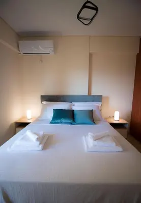 a bedroom with a large white bed with blue pillows at Athens Acropolis View Penthouse-Center of Athens in Athens
