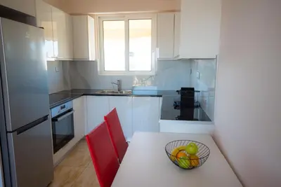 a kitchen with a bowl of fruit on a table at Athens Acropolis View Penthouse-Center of Athens in Athens