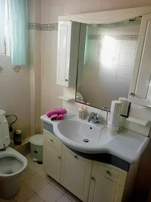 a bathroom with a sink and a toilet and a mirror at Τάνια in Anavissos