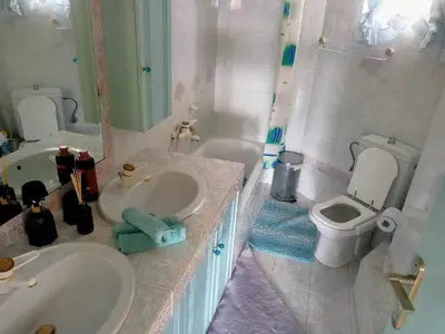 a bathroom with two sinks and a toilet at Τάνια in Anavissos