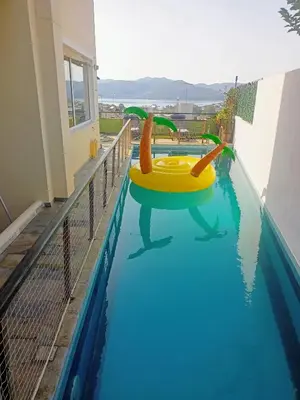 a pool with a yellow inflatable slide in the water at Τάνια in Anavissos