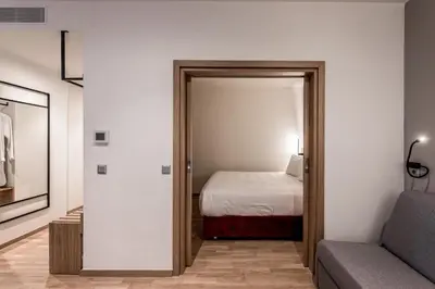a room with a bed and a door leading to a bedroom at Urban Frame Acropolis in Athens