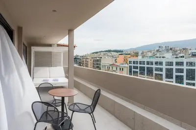 a balcony with chairs and a table and a view at Urban Frame Acropolis in Athens