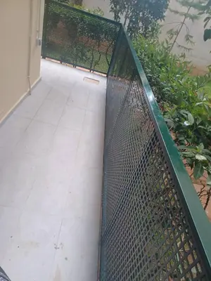 a chain link fence in front of a walkway at Cozy Renovated Apartment in Athens