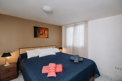 a bedroom with a bed with two towels on it at Penthouse of diamond in Athens