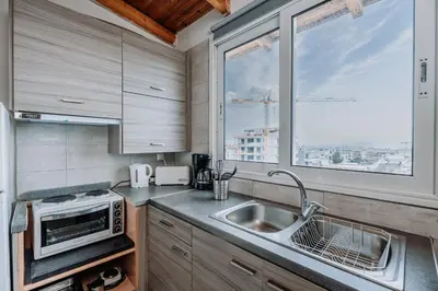 a kitchen with a sink and a window at Penthouse of diamond in Athens