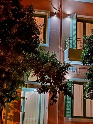 a building with a green door and a balcony at City Life Metro Ambelokipi in Athens
