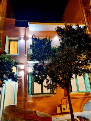 a building with windows and a tree in front of it at City Life Metro Ambelokipi in Athens