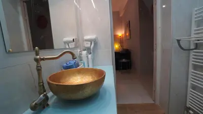 a bathroom with a wooden bowl sink on a counter at City Life Metro Ambelokipi in Athens