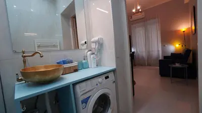 a bathroom with a sink and a washing machine at City Life Metro Ambelokipi in Athens