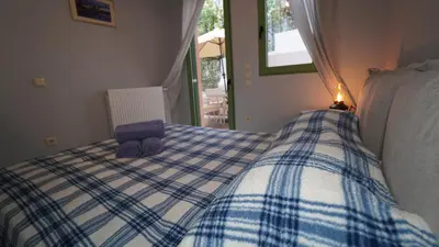 a blue and white bed with a purple suitcase on it at City Break Metro Ambelokipi in Athens