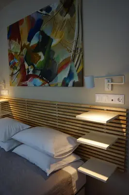 a bedroom with a bed with a painting on the wall at Historic Center Luxury Studio Apartment in Athens