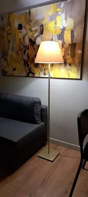 a lamp in a living room next to a couch at Historic Center Luxury Studio Apartment in Athens