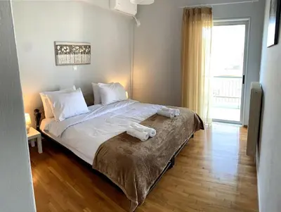 a bedroom with a large bed with white sheets at The Temple of Comfort in Athens