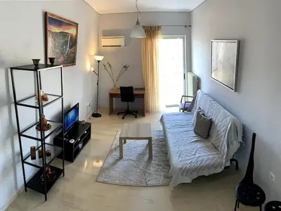 a living room with a couch and a table at The Temple of Comfort in Athens