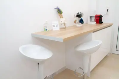 a kitchen with a counter with two white sinks at Acropolis Luxurious Legacy in Athens