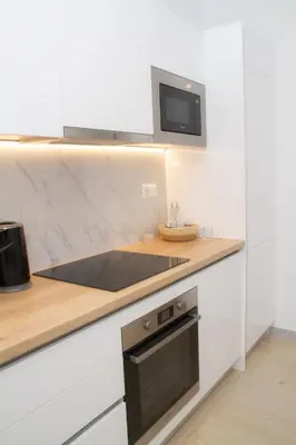 a kitchen with a stove and a microwave at Acropolis Luxurious Legacy in Athens