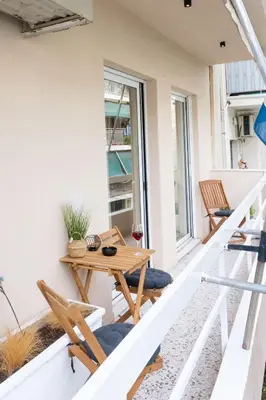 a patio with a table and chairs on a balcony at Acropolis Luxurious Legacy in Athens