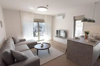 a living room with a couch and a table at Bright apartment in the New building (FORM_F1) in Athens