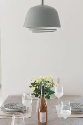 a table with a bottle of wine and glasses at Bright apartment in the New building (FORM_F1) in Athens