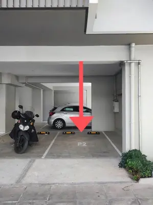 a car parked in a parking garage with a red arrow at Bright apartment in the New building (FORM_F1) in Athens
