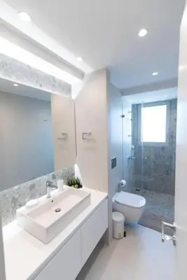 a white bathroom with a sink and a toilet at Bright apartment in the New building (FORM_F1) in Athens