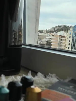 a view of a city skyline from a window at Modern Cityview Flat - 1 min to Metro - Walk to Acropolis in Athens