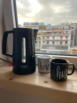 a coffee maker and two mugs sitting on a window sill at Modern Cityview Flat - 1 min to Metro - Walk to Acropolis in Athens
