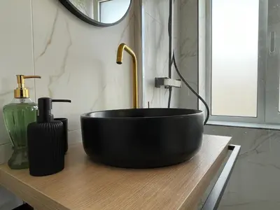 a black bowl sink on a wooden counter in a bathroom at Modern Cityview Flat - 1 min to Metro - Walk to Acropolis in Athens